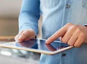 man_holding_ipad_300 home watch services with electronic reporting and emailed reports.